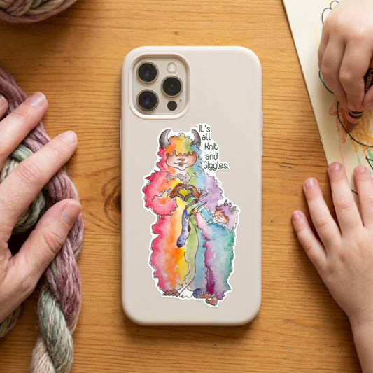 'It's All Knit and Giggles' hand-painted watercolor sticker — a rainbow wool monster cheering on a smaller one learning to knit.